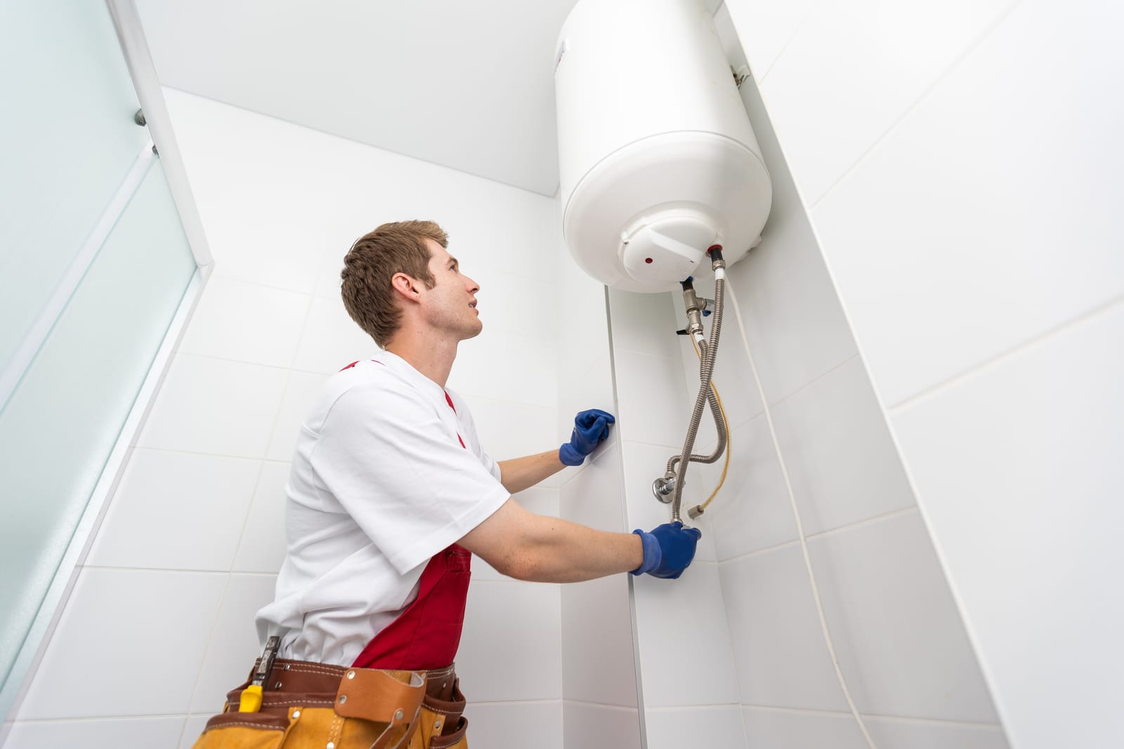 55184022 Professional Plumber Checking A Boiler And Pipes Boiler Service Concept Min